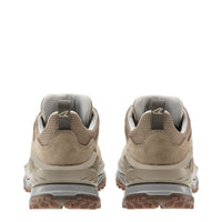 Pair of beige hiking shoes with visible brand logo on a white background