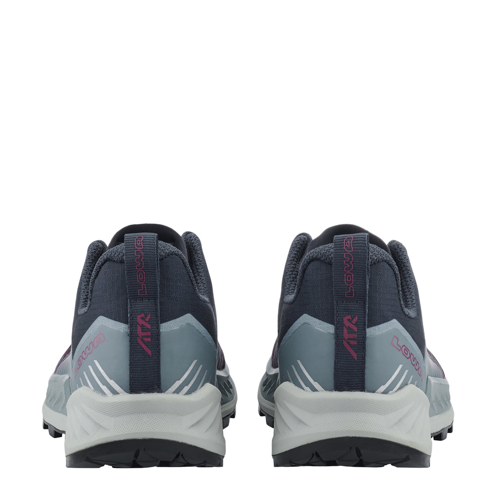 A pair of trail running shoes shown from the back, featuring a dark navy upper, light gray midsole panels, and magenta accents on the heel pull tabs and branding.