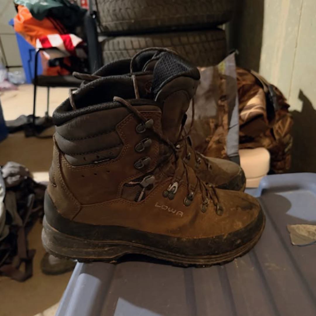 A pair of dusty leather boots in a garage