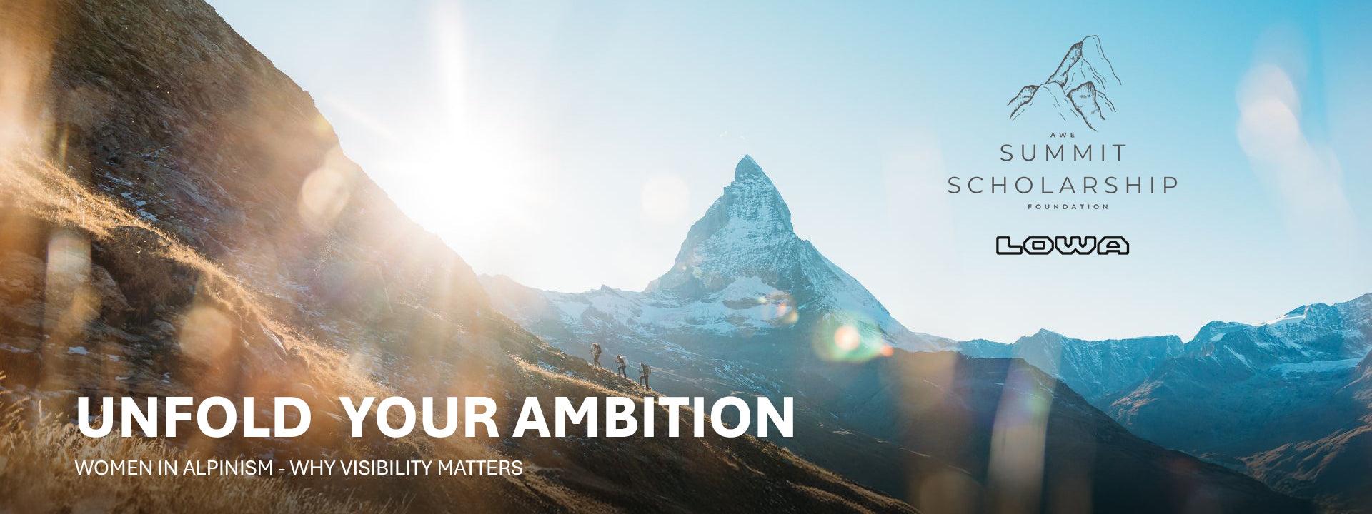 Mountain peak with 'Summit Scholarship' and 'Lowa' logos, text 'Unfold Your Ambition' and 'Women in Alpinism: Why Visibility Matters'.