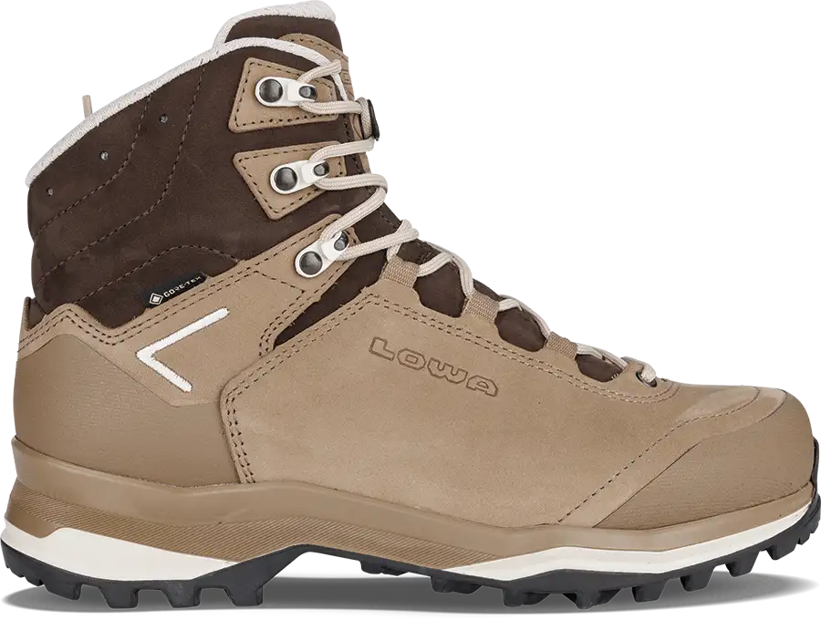 A lowa hiking boot in tan and brown suede and mesh, featuring white laces, a white chevron logo on the side, and a black and white outsole.